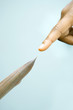 Finger pointing at tip of leaf, extreme close-up