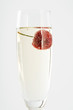 Glass of champagne with a cherry floating in it, close-up
