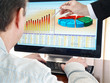 Analyzing financial data and charts on computer screen. Analyzing financial data and charts on computer screen.