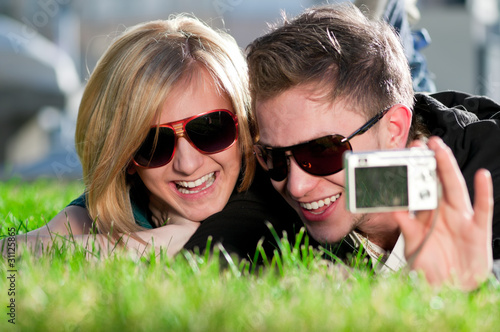 Photo: Emotional teenage couple photographing outdoor Emotional teenage couple photographing outdoor