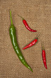 Red and green peppers on a piece of canvas