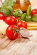 pasta, olive oil and tomatoes on the wood background pasta, olive oil and tomatoes on the wood background