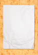 crumpled white paper on wood background