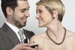 Foto: Beautiful woman wearing luxury jewellery, while the man presents an exclusive ring. The necklace is a south sea pearl necklace. Beautiful woman wearing luxury jewellery, while the man presents an exclusive ring. The necklace is a south sea pearl necklace.