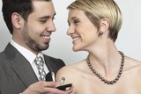 Foto: Beautiful woman wearing luxury jewellery, while the man presents an exclusive ring. The necklace is a south sea pearl necklace. Beautiful woman wearing luxury jewellery, while the man presents an exclusive ring. The necklace is a south sea pearl necklace.