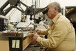 Photo: Jeweller working on gem stone to cut and polish and make exclusive jewellery designs Jeweller working on gem stone to cut and polish and make exclusive jewellery designs