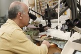 Photo: Jeweller working on gem stone to cut and polish and make exclusive jewellery designs Jeweller working on gem stone to cut and polish and make exclusive jewellery designs