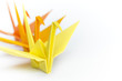 Three paper birds lining up on a white background