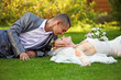 Photo: Portrait of happy newlyweds on grass in park Portrait of happy newlyweds on grass in park