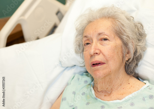 Photo: Elderly 80 year old woman with Alzheimer in a hospital bed Elderly 80 year old woman with Alzheimer in a hospital bed