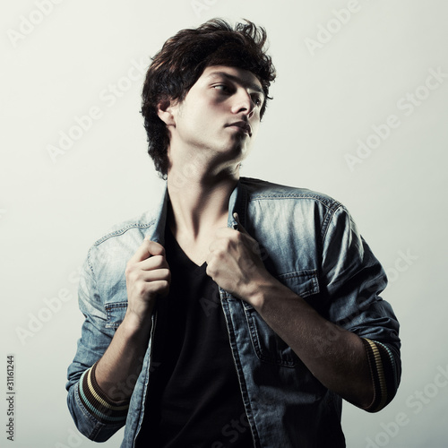 Photo: Fashion portrait of the young beautiful man in studio Fashion portrait of the young beautiful man in studio