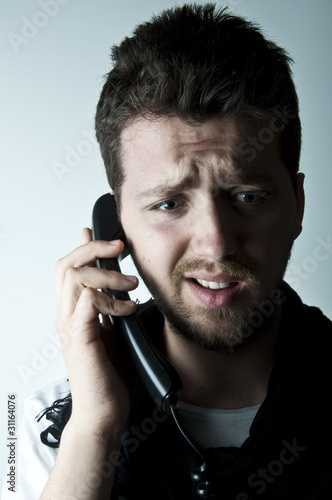 Photo: Young man on the phone Young man on the phone