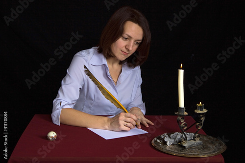 Photo: portrait of beautiful brown-haired girl writing work portrait of beautiful brown-haired girl writing work