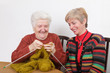 Photo: Two generations senior and mature womans knitting Two generations senior and mature womans knitting