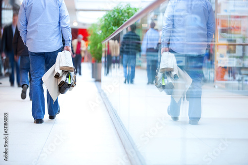 Photo: People in rush in a modern shopping mall. People in rush in a modern shopping mall.