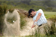 Foto: Golfer playing a bunker shot Golfer playing a bunker shot