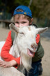 Boy hugging a goat Boy hugging a goat