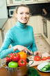Happy smiling woman cooking with vegetables, at home Happy smiling woman cooking with vegetables, at home