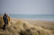 A senior couple walking, looking out to sea