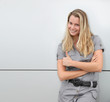 Smiling blond woman on grey background
