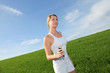 Beautiful blond woman jogging in country field