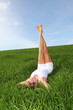 Photo: Woman laying down green field with legs up Woman laying down green field with legs up