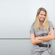 Blond woman standing on grey background