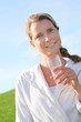 Woman drinking natural water in green field