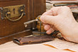 Old female hand with a key