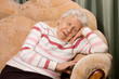 The elderly woman sleeps on a sofa