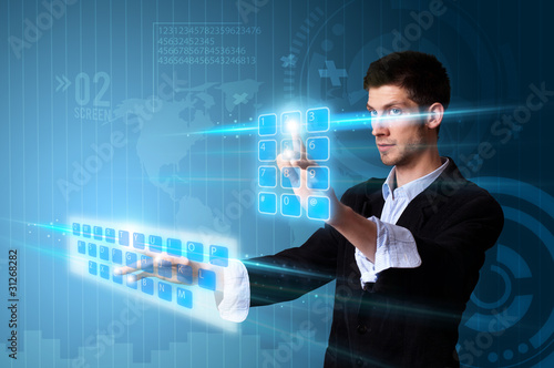 Foto: Man pressing modern touch screen buttons with a blue technology Man pressing modern touch screen buttons with a blue technology