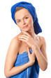 Portrait of young beautiful woman with blue towel after bath