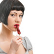 Closeup of young girl with red chilli in mouth Closeup of young girl with red chilli in mouth