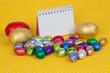 Blank notebook with Easter chocolate eggs. Insert your text here