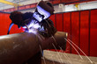 worker weld metal in factory and sparks