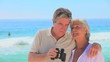 Mature couple using binoculars 