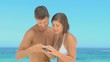 Beautiful couple taking photos on a beach