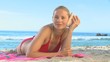 Video: Blonde woman listening to a shell Blonde woman listening to a shell