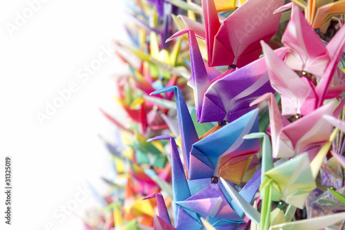 Photo: Colorful paper birds hanging together using fishing lines Colorful paper birds hanging together using fishing lines
