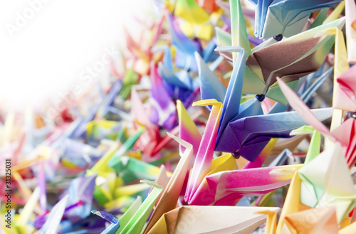 Photo: Colorful paper birds hanging together using fishing lines. Colorful paper birds hanging together using fishing lines.