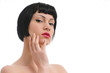close up shot of a pretty young female touching her face close up shot of a pretty young female touching her face