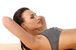 A young and sporty brunette is doing stretching exercises