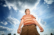 Photo: Power boy outdoors over sunny sky. View from below. Power boy outdoors over sunny sky. View from below.