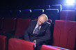 Photo: Bald man sleeping in empty cinema movie theater Bald man sleeping in empty cinema movie theater