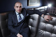 Handsome bald business man in suit in luxury interior