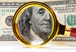 magnifying glass over money