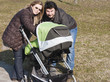 Photo: Happy Family Walking with Stroller Happy Family Walking with Stroller