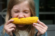 Young Girl Eating Corn