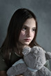 Sad young girl with toy Sad young girl with toy