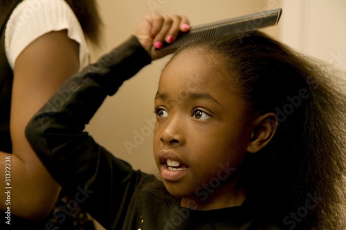 Photo: Girl Combing Hair Girl Combing Hair